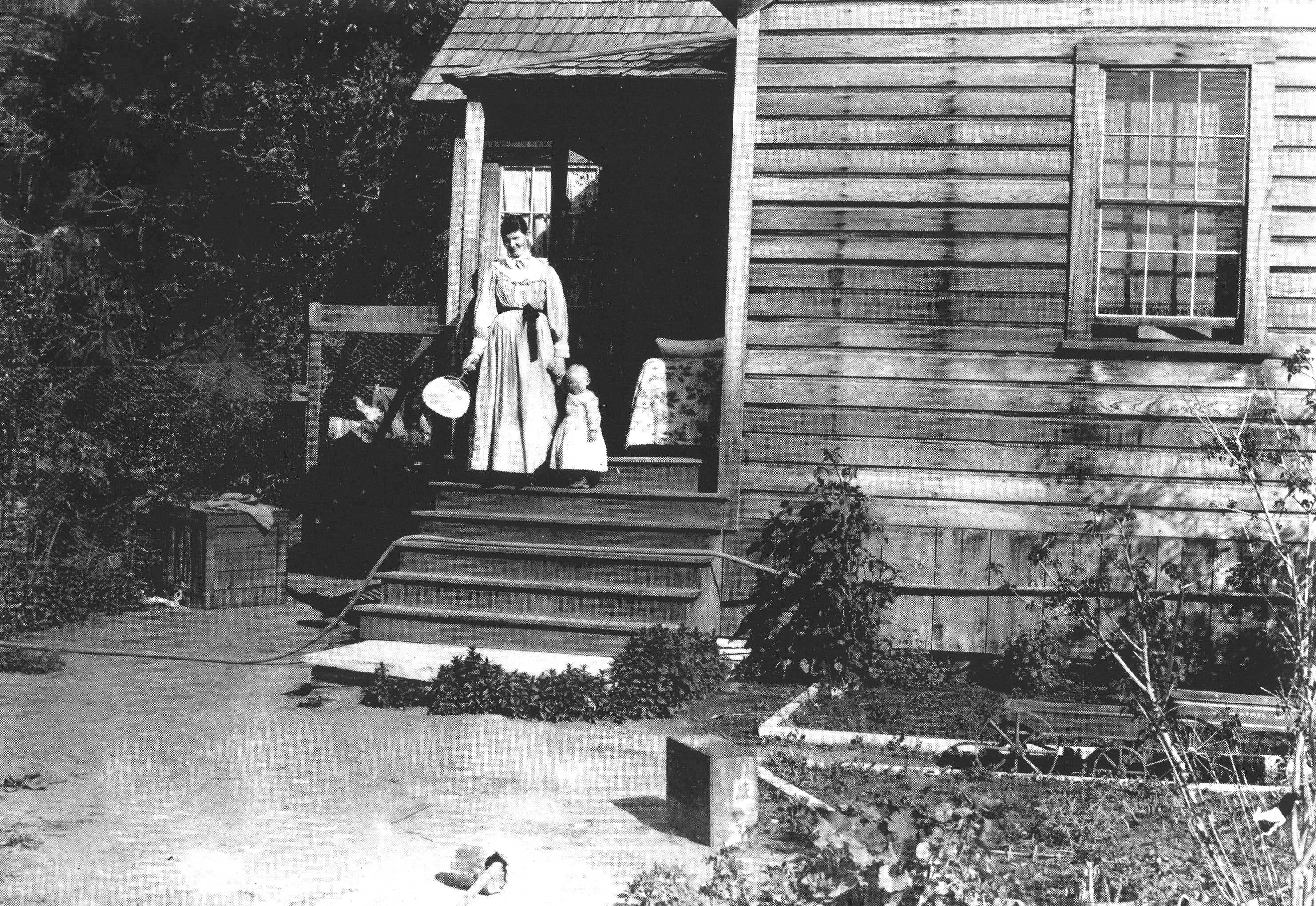 woman with child on porch of a house