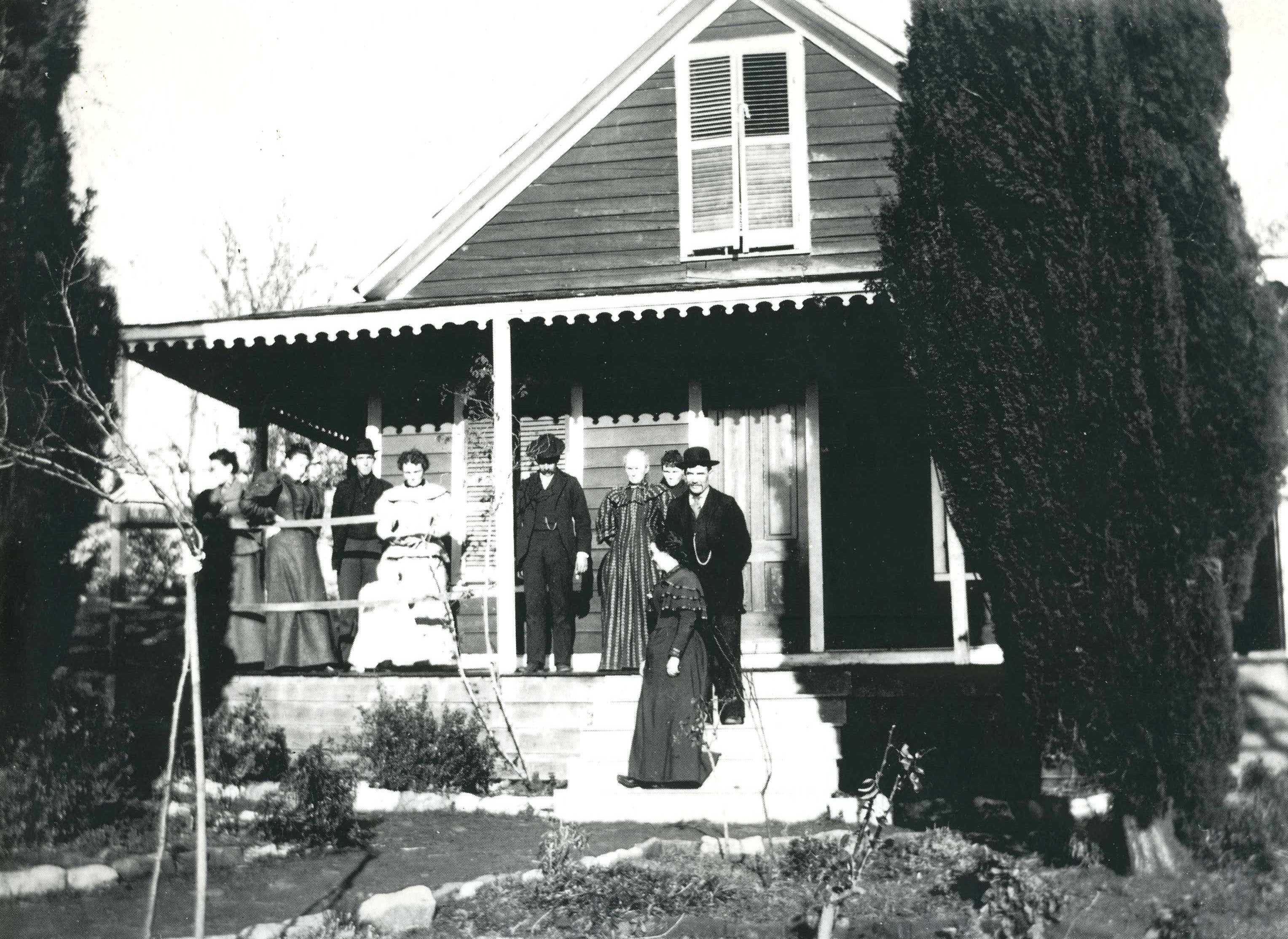 people standing on front porch of a house