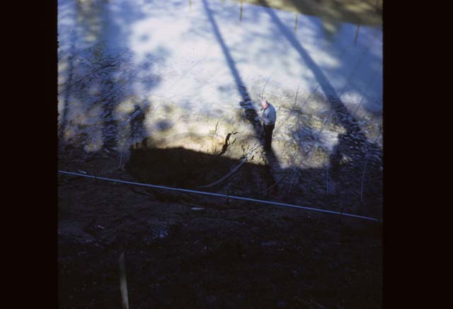 person in partially full pond