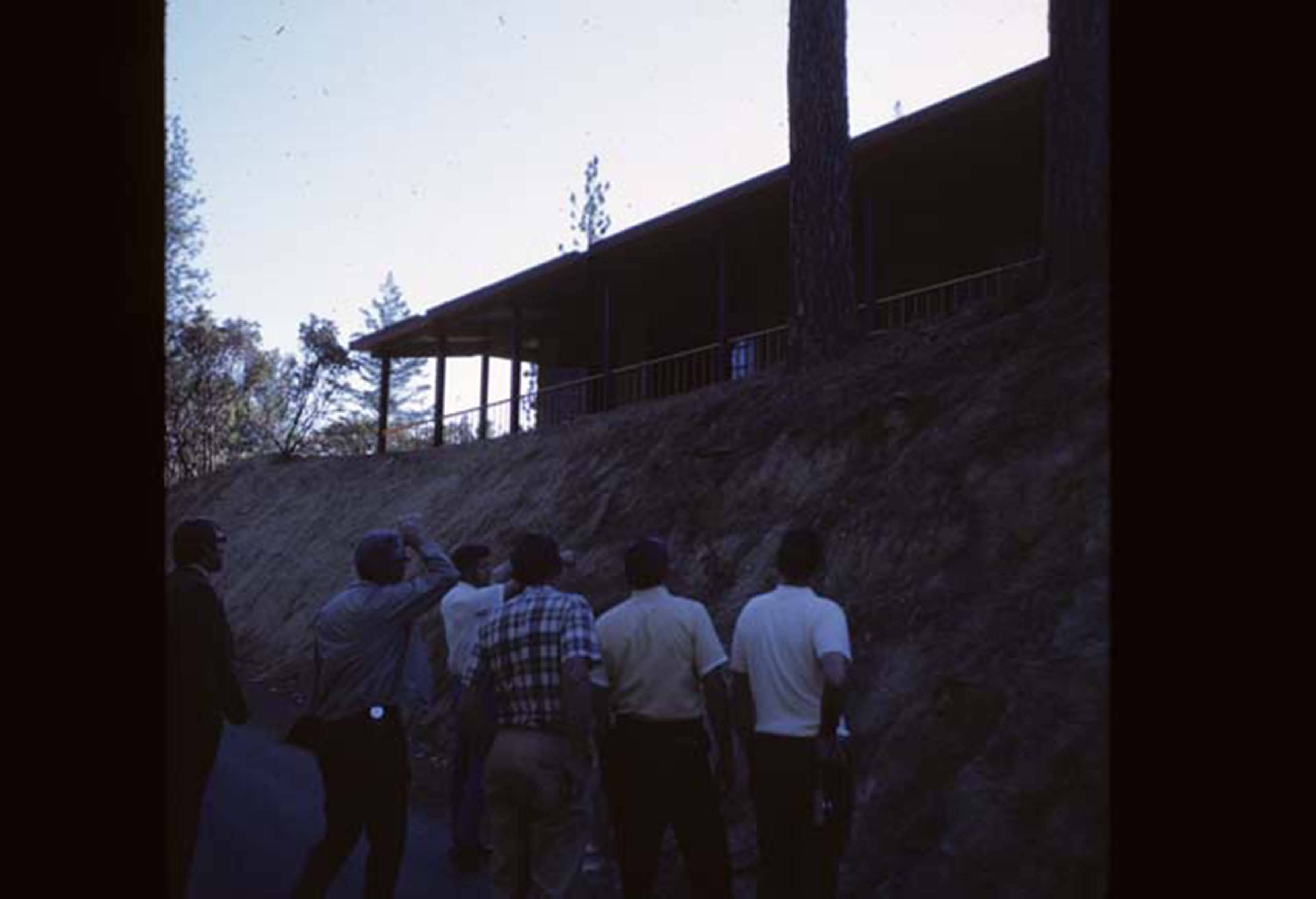 people looking up at building